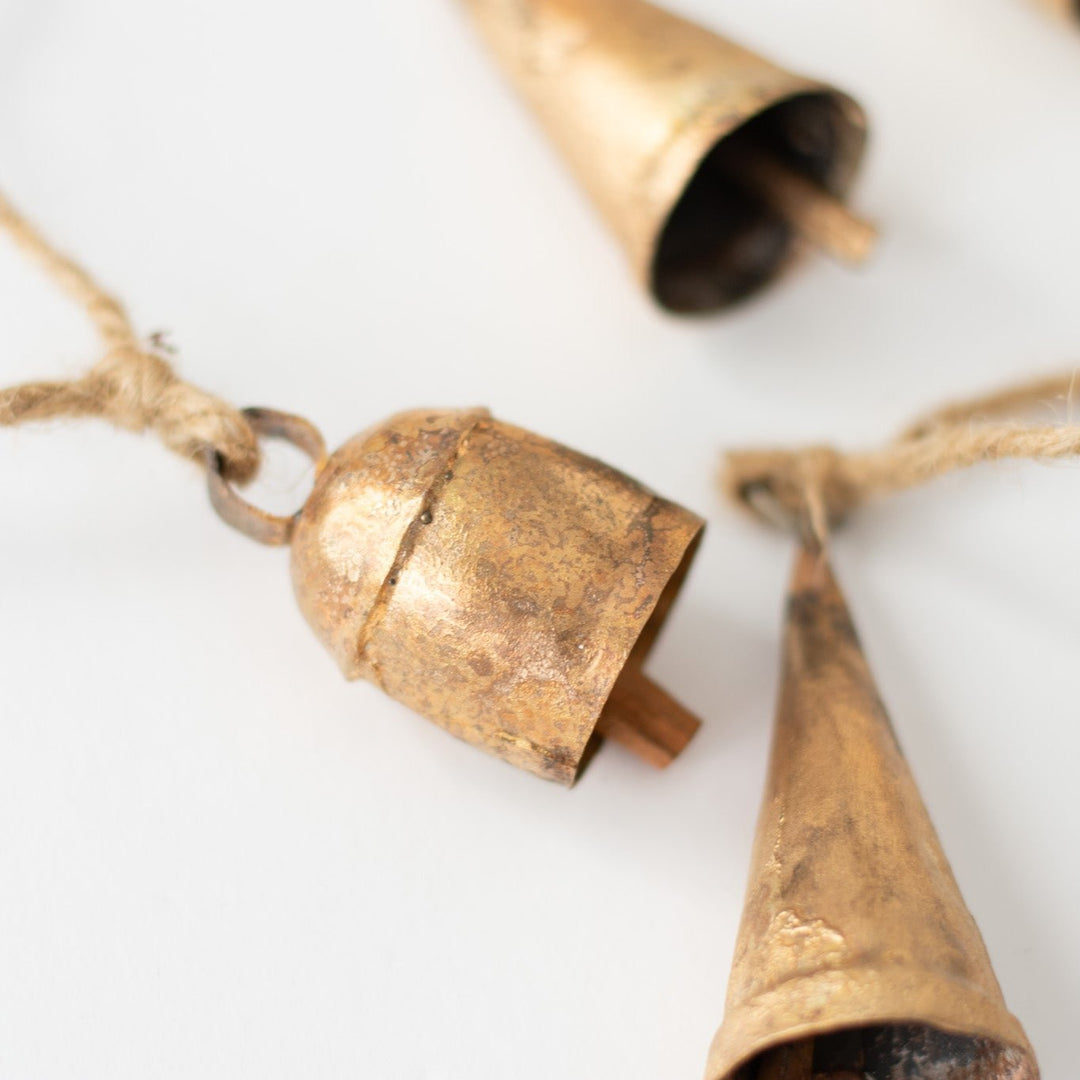 A close-up of a garland with gold bells