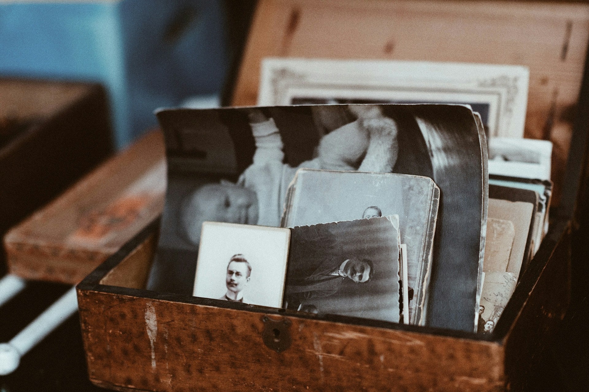 photo of a bunch of black and white photos sitting in various angles in a brown leather box